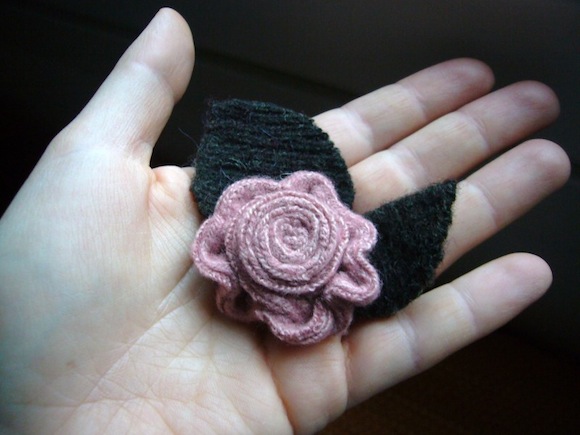 fiore-rosa-su-mano-lontano
